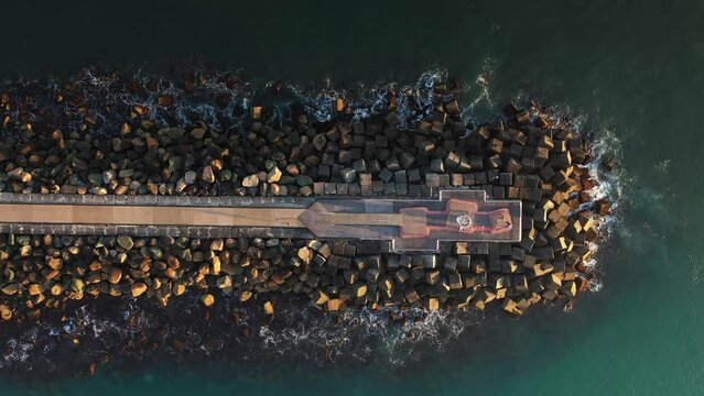 Aerial top down descent over the tip of Southport Spit breakwall. Gold Coast, Australia.