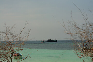 Many fishing boats in the middle of the sea are hunting fish.