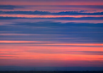 Fototapeta na wymiar 夕焼けの空筋のように真っ直ぐな雲青とピンクのコラボレーション