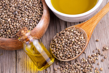 Hemp seeds and hemp seed oil on wooden background