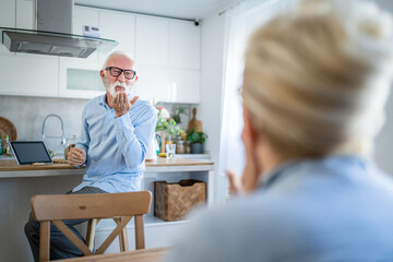 senior couple man and woman husband and wife at home talk