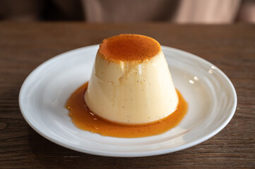 A sweet pudding served on a plate. Pudding is a popular dessert and snack. It tastes sweet, and comes in many flavors.