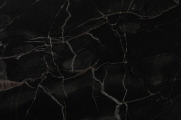 Black marble surface as background, closeup view