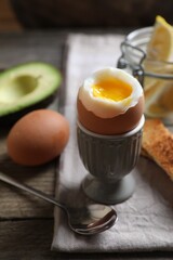 Soft boiled egg served for breakfast on wooden table