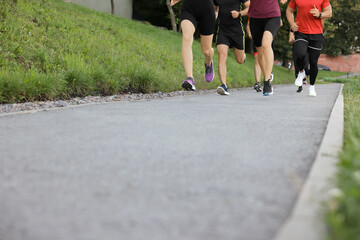 Group of people running outdoors, closeup. Space for text