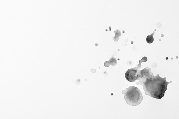 Naklejka premium Blots of black ink on white background, flat lay. Space for text