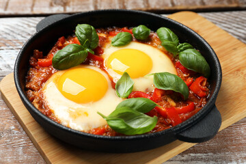 Delicious Shakshuka on wooden table, closeup view