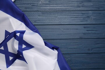 Flag of Israel on blue wooden background, top view and space for text. National symbol