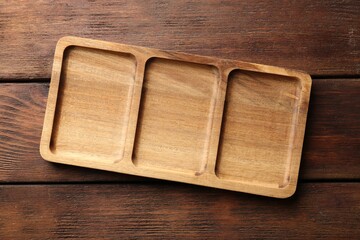 New compartment tray on wooden table, top view