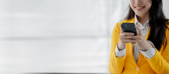 Businesswoman is working in the office and talking on the phone with a partner, Entrepreneurs use...