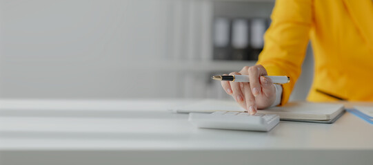 Accountant calculating numbers on calculator, Auditor is working on accounting in the office,...