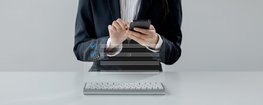 Businesswoman is sitting and working in the office, The supervisor is making a checklist, The operator is looking at the details of the various checklists that the employee has brought.