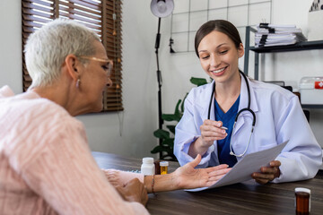 Caucasian Female doctor are advice medication and vitamin daily to caucasian elderly patient
