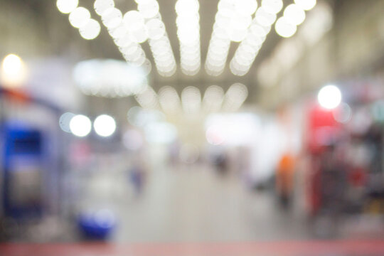 Large High Building Premises With People Walking Inside. Blurred Background.