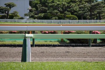 Close up of horse race dirt track and railings
