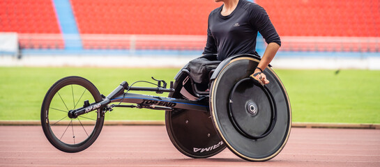Close up of para-athletes male disabled practice handcycling in stadium. 