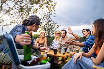 Group of diverse friend having outdoors camping party together in tent. 