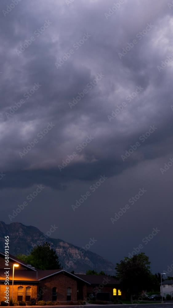 Canvas Prints vertical rainstorm swirling in timelapse as lightning flashes as it rolls over the mountains in utah