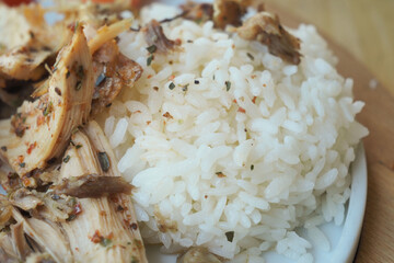 Closeup of Cooked white rice and chicken on a plate 