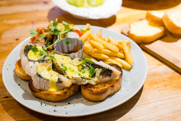 Butter bread toast with sea bass fillet in the restaurant