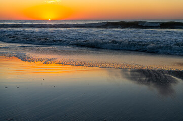 Sunrise Reflections on beach (sun on left)