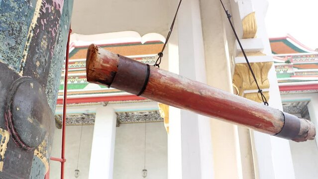The hanging wooden log - beam used for strike at bell in a Buddhist temple, Thailand