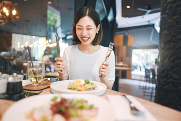 Asian woman eating healthy food at cafe restaurant city break on weekend lifestyle