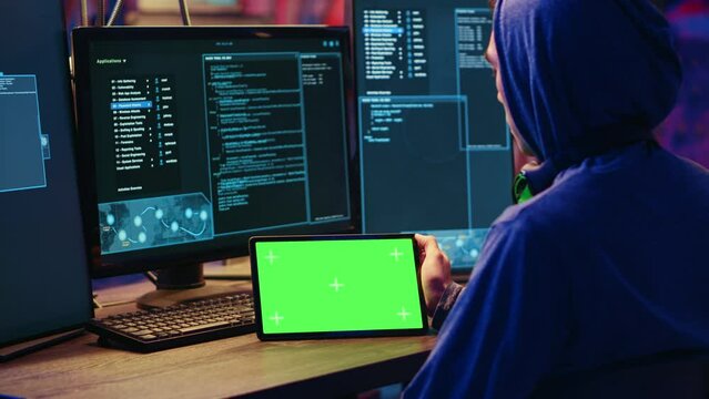 Hackers doing computer sabotage using encryption trojan ransomware on green screen tablet. Cybercriminals use mockup device to demand ransom money from victims in exchange for access to their data