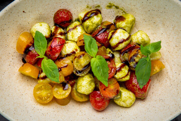  salad of yellow and red cherry tomatoes of different varieties with herbs side view