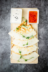 crispy flatbreads stuffed with meat, herbs, lime and two sauces, side view