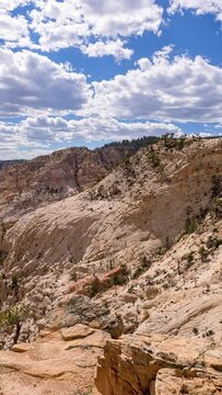Vertical Timelapse from Hells Backbone in the Escalante desert in Utah looking down the canyon as clouds move through the sky.