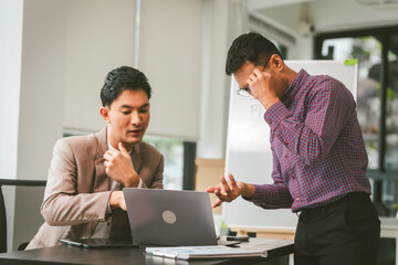 Two professionals in meeting, one presenting "Business, Plan, Success" on whiteboard, another observing and holding a clipboard. Asian businessman, Colleagues, Middle-age