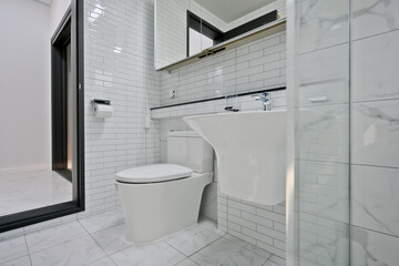 A toilet, sink, and shower area with a glass partition are the most common bathroom layouts