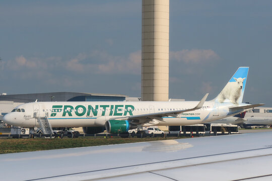 Frontier Airlines aircraft and the control tower at Hartsfield-Jackson Atlanta International Airport in USA. August 21, 2023