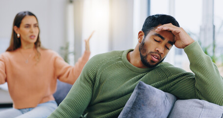 Fototapeta premium Couple, home and fight on couch, sad and angry with stress, mental health and headache with relationship crisis. Man, woman and questions on lounge sofa with conflict, anxiety and mistake in marriage