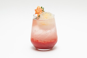 A cocktail in a glass against a white background