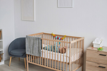 Background image of cozy room interior with baby playing with toy in wooden crib, copy space