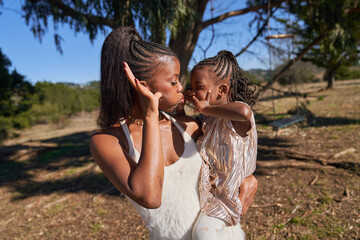 Obraz premium Young Black Mother with Young Toddler Daughter at the Park Bonding Having Fun 