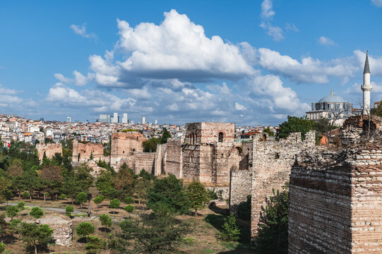 Panorama of the fortress walls of Constantinople and the modern city of Istanbul on a sunny day. Cloudy sky over Istanbul.