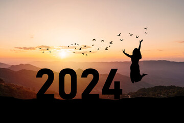 Young woman enjoying and celebrating New Year 2024 with the beautiful sunrise sky and landscape