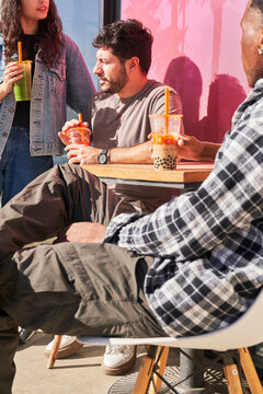 Friends drink boba at outdoor table 