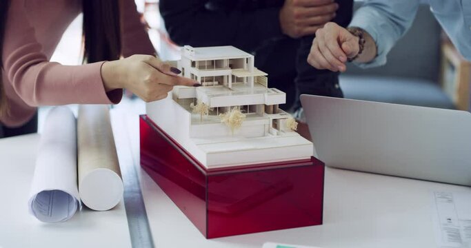Collaboration, hands and architect team work on model 3D house, condominium or plan real estate development. Business, closeup and group property design, architecture or condo building infrastructure