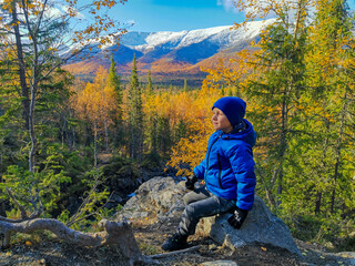 A boy on the background of an autumn Arctic landscape in the Khibiny mountains. Kirovsk, Kola...
