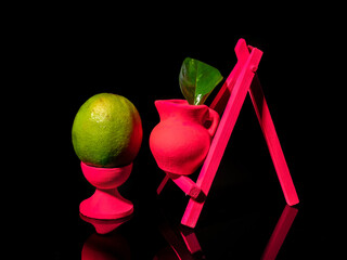 Composition with lemon at the easel on a black background
