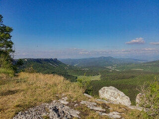 Fototapeta premium Mangup-Kale cave city, sunny day. Mountain view from the ancient cave town of Mangup-Kale in the Republic of Crimea, Russia. Bakhchisarai.