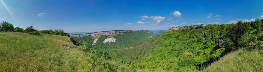 Fototapeta na wymiar Mangup-Kale cave city, sunny day. Mountain view from the ancient cave town of Mangup-Kale in the Republic of Crimea, Russia. Bakhchisarai.