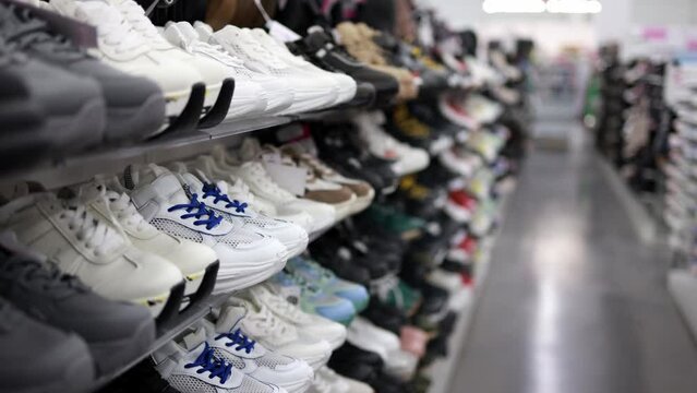 Shelves with sneakers in a store.