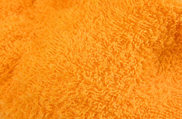 湿ったオレンジ色タオルの素材に