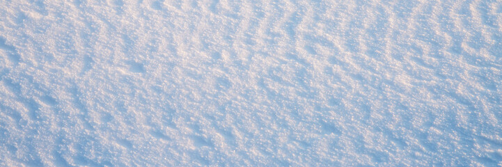 Beautiful winter background with snowy ground. Natural snow texture. Wind sculpted patterns on snow...
