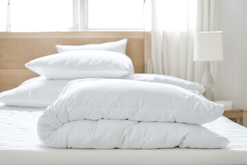 Clean and pure white hotel room bedding, pillows and quilts